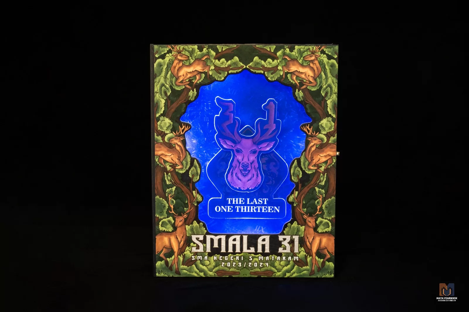 Kover buku tahunan SMAN 5 Mataram angkatan 31 bertema The Last One Thirteen dengan ilustrasi rusa biru bercahaya di tengah hutan.